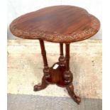 A 20th century carved shaped table, standing on a