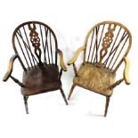 A pair of oak wheel back open armchairs