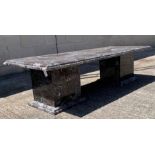 A 20th century black marble table, standing on ste
