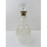 A clear glass decanter with hobnail cut decoration