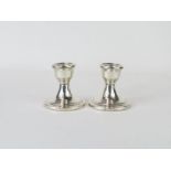 A pair of silver desk candlesticks, with loaded bases,