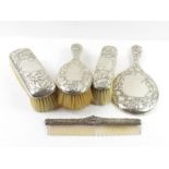 A silver dressing table set comprising hand mirror