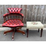 A modern red leather office chair on swivel base,