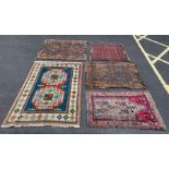 A collection of five carpets and rugs, various des