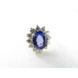 A tanzanite and diamond cluster ring, the oval tan