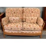 An Ercol elm Renaissance sofa and single armchair