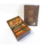 A 20th century mahjong set, with coloured stick co