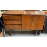 A mid century teak sideboard, with a two door cupb