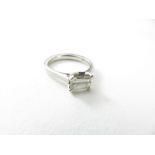 A platinum diamond solitaire ring, the emerald cut