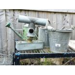 Collection of galvanized watering cans, buckets an