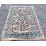 Red/black/beige rug measuring 195cm x 133cm