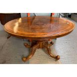Oval walnut centre table with carved pedestal base
