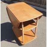 A mid century drop leaf elm and beech Ercol trolle