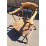 A 20th century oak smoker/tub chair