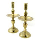 A pair of brass heemskerk candlesticks, converted