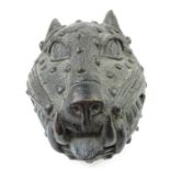 A heavy metal mask of a stylised leopard, the spot
