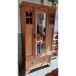 An early 20th century pine single wardrobe, with a