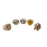 A collection of five rings, one decorated with an