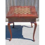 A 20th century rosewood games table, with inlaid b