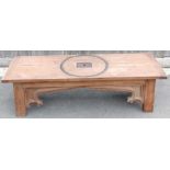 A 20th century carved coffee table, inlaid with a