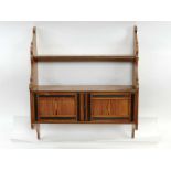 A 20th century pitch pine set of hanging shelves,