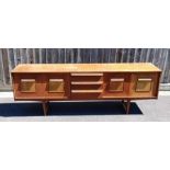 A mid century teak sideboard, two cupboard section