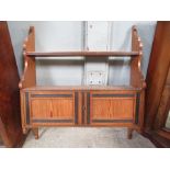 ## WITHDRAWN ## An early 20th century pitch pine hanging unit, wit