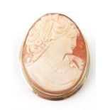 An oval cameo shell brooch, decorated with a lady