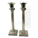 A pair of silver plated column candlesticks, each