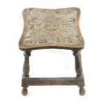 A 20th century oak carved stool