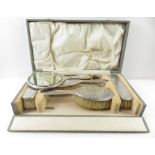 A cased silver dressing table set to include hand