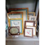Shelf of framed pictures