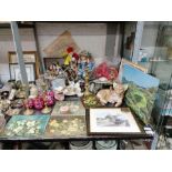 Shelf of items to include flower paintings, doll,