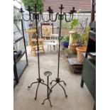 2 cast iron tall candle holders along with 1 other