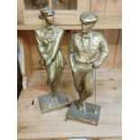 2 gold coloured statues of golfers