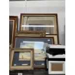 Shelf of framed pictures and prints along with som