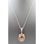 An amber pendant, with naturalistic style mount, i