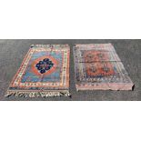 Two decorative middle eastern rugs, the first with