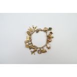 A 9ct gold curb link charm bracelet with heart pad