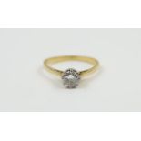 A diamond single stone ring, the band marked '18ct