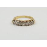 An 18ct gold diamond half eternity ring, the claw