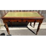 A 20th century mahogany side table, with a green l
