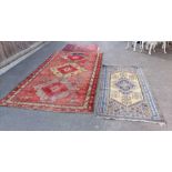 Three 20th century rugs, the largest with three ce