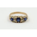 A 9ct gold sapphire and diamond ring, with scroll