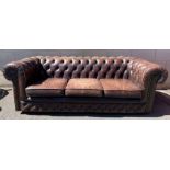 A Chesterfield button back sofa, upholstered in a brown