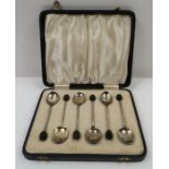 A set of coffee bean end spoons, each bowl back wi