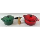 A red two handled Le Creuset cooking pot, along wi