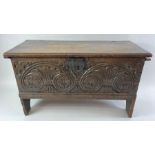 A 19th century oak coffer, with carved front panel