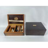An oak humidor box along with a Macanudo label to