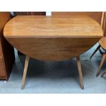 An elm and beech Ercol drop leaf table, standing o